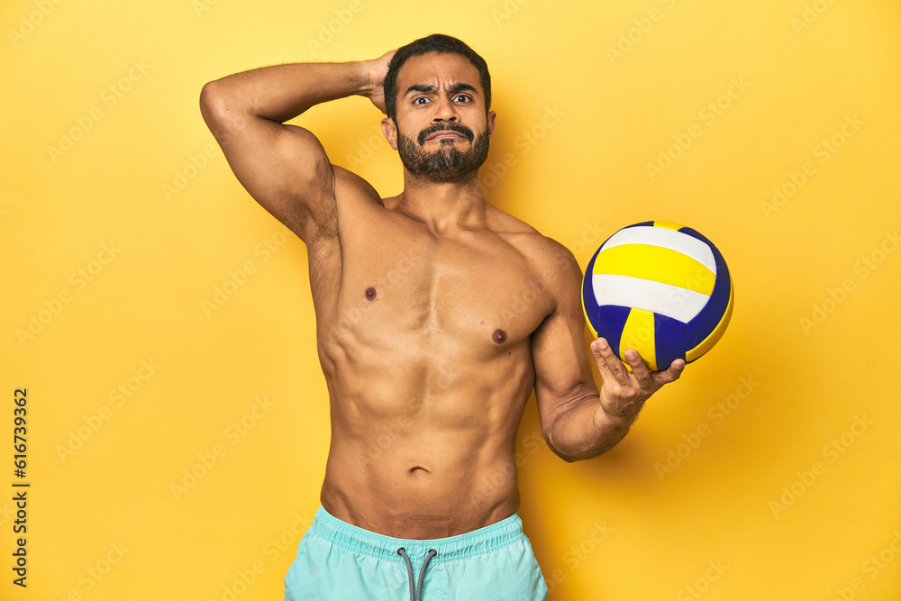 Young athletic Latino man, shirtless in swimwear, holding a volleyball having an idea, inspiration concept.