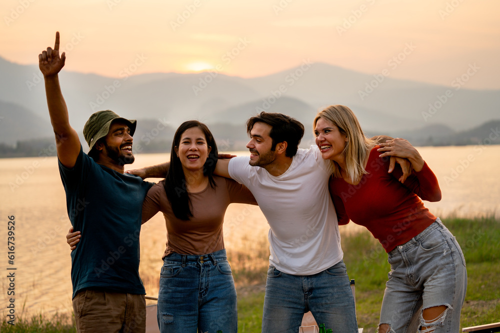 Group of friends with multi-ethnic hug together and stand in front of sunset light near lak of public park with happiness. Group of friends with multi-ethnic hug together and stand in front of sunset light near lak of public park with happiness.