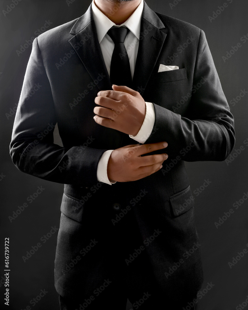 © Stock_Vision - Confident Handsome Young Man In Dark Suit Adjusting cuff Isolated On Dark Background © Stock_Vision - Confident Handsome Young Man In Dark Suit Adjusting cuff Isolated On Dark Background