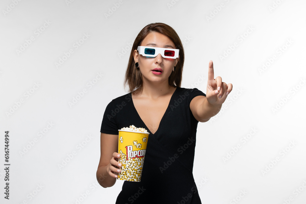 front view young female holding popcorn in d sunglasses and watching movie on a white background movies cinema lonely film