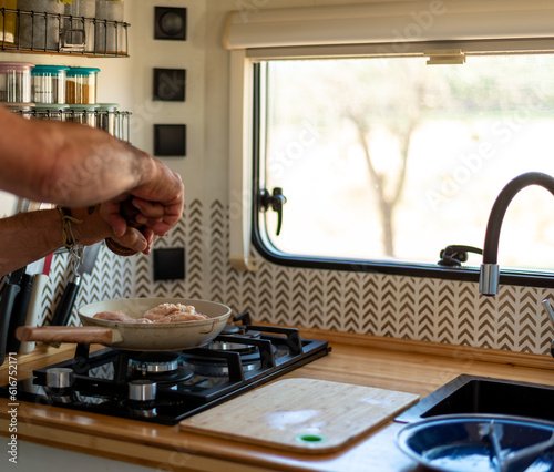 Wallpaper Mural older man cooking in his motorhome,Savoring Freedom Torontodigital.ca