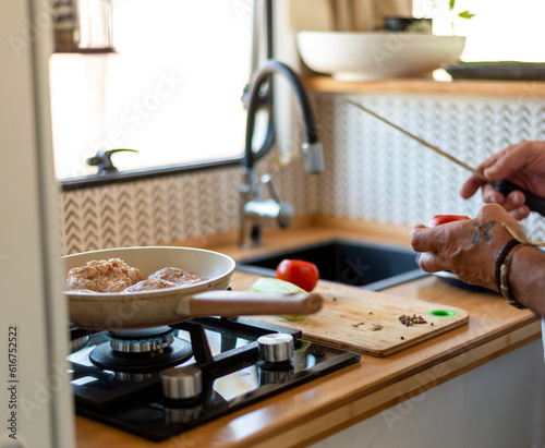 Wallpaper Mural older man cooking in his motorhome,Gourmet Delights: Indulging in Culinary Creations During Retirement Torontodigital.ca