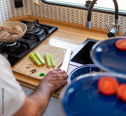 Wallpaper Mural older man cooking in his motorhome,Relaxed Culinary Escapades: Unwinding with Cooking Adventures Torontodigital.ca