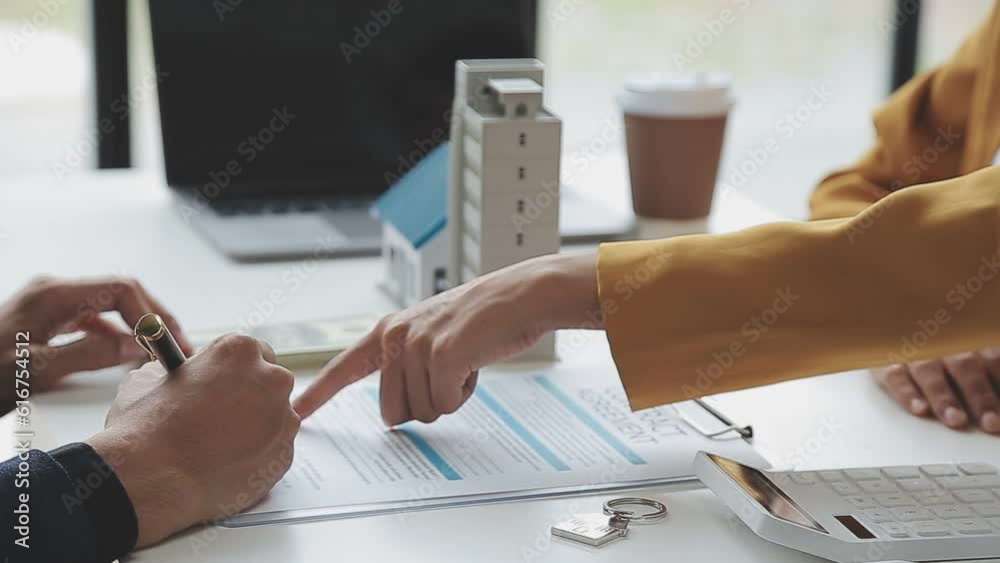 Real estate broker agent presenting and consult to customer to decision making sign insurance form agreement, buy and sell home model, concerning mortgage loan offer for and house insurance