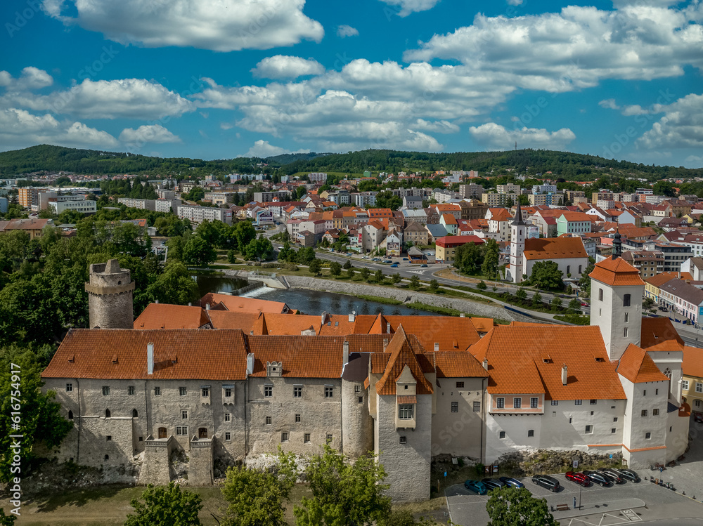Aerial view of Strakonice castle next to the Otava river in Czechia with Gothic, Baroque palace and restored circular donjon with edge called Rumpal tower