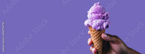 Female hand holding ice cream cone on purple background. Banner with copy space. Generative AI.