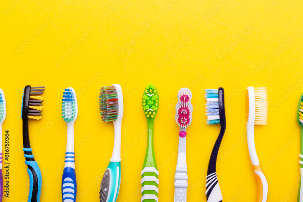 Toothbrushes on a yellow background. Health care, dental hygiene. Space for text. Toothbrushes on a yellow background. Health care, dental hygiene. Space for text.