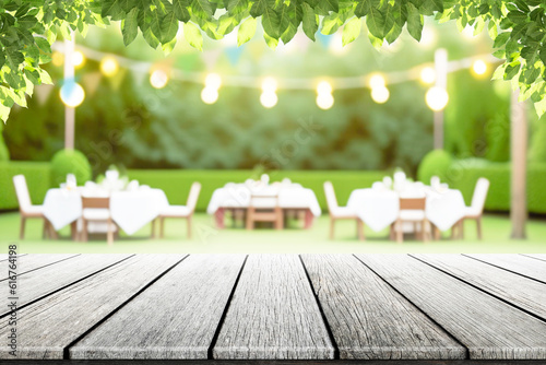 Empty wooden table with party in garden background blurred.