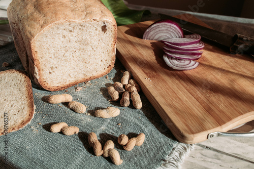 Homemade wheat flour bread with peanuts and red onion on the table
