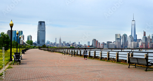 a view of Manhattan city skyline from battery park , a bridge on Hudson river,  new jersey, USA 