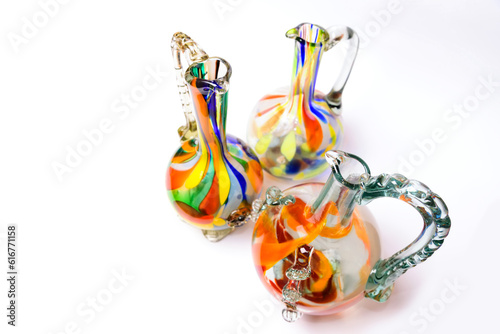 Graceful embellished murano glass vase and jug with multi colored swirls pattern.