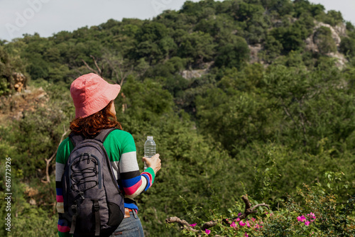 Asian,Portrait of backpacker with a rucksack standing on the mountain hill while enjoying nature scenery view in summer holidays