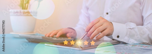 Customer review concept. Businessman using laptop with star rating icon.