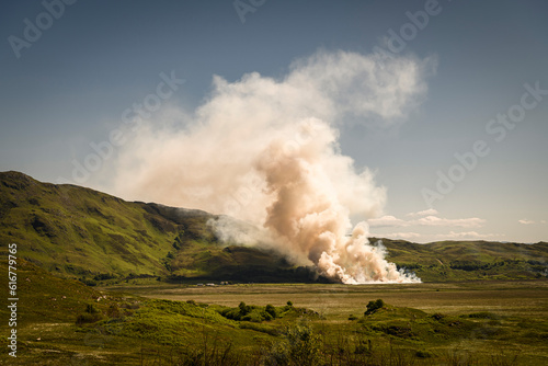 A summer HDR image of stubble being burnt off in a field during a very hot and dry period of weather in South Morar, Scotland. 5th June 2023 photo