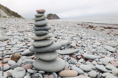 Canvas Print stack of stones on beach