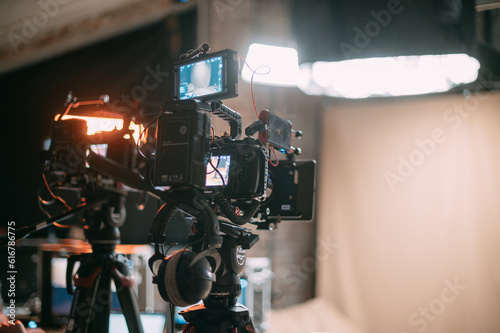 Professional cinema and video camera on the set. Shooting shift, lighting fixtures, shooting equipment and the team.
