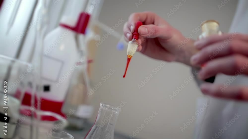 Witness the precise injection of a laboratory solution into a flask, as