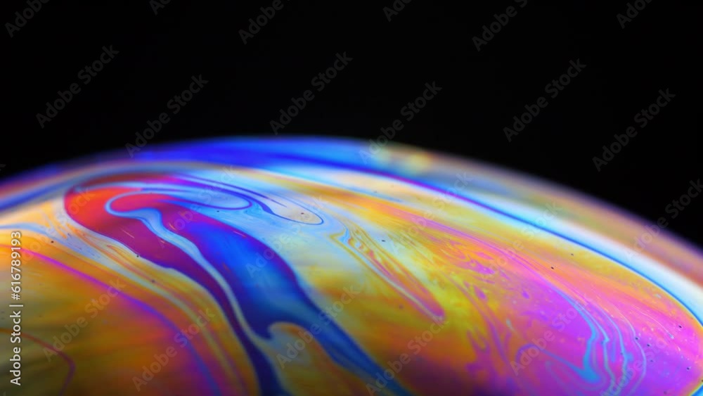 Rainbow multilayer film. Spherical abstraction of iridescent blue, yellow and red colors with soft focus. The natural environment.