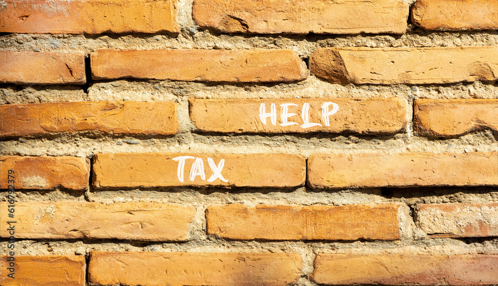 Tax help symbol. Concept words Tax help on beautiful brown bricks on a beautiful brick wall background. Business, support and tax help concept. Copy space. Tax help symbol. Concept words Tax help on beautiful brown bricks on a beautiful brick wall background. Business, support and tax help concept. Copy space.