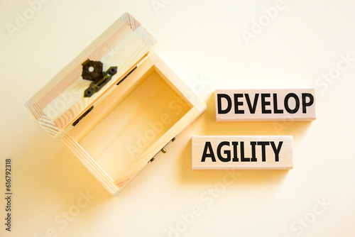 Develop agility symbol. Concept words Develop agility on wooden blocks on a beautiful white table white background. Empty wooden chest. Business, support and develop agility concept. Copy space.