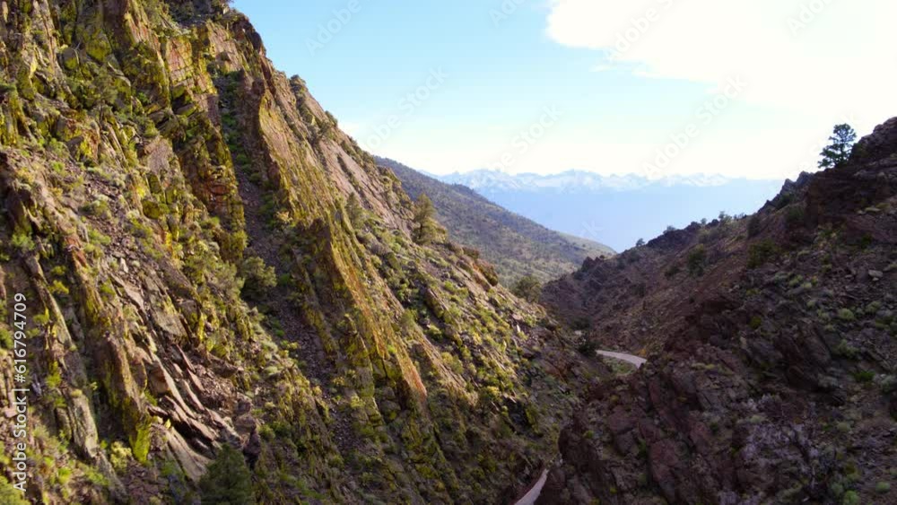 Aerial Shot Of Empty Winding Road Amidst Mountains Against Sky, Drone Flying Forward Over Valley - Mammoth Lakes, California Aerial Shot Of Empty Winding Road Amidst Mountains Against Sky, Drone Flying Forward Over Valley - Mammoth Lakes, California