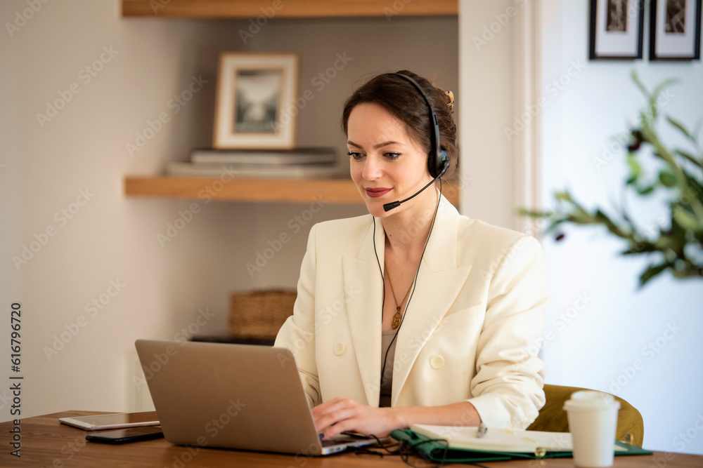 Young woman with headset and laptop working from home Young woman with headset and laptop working from home