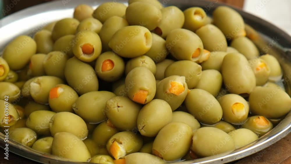 Different marinated olives and local food on street market in Gdansk, Poland. Selling and buying street food. Assortment of Appetizing olives on market. Tourist attraction Different marinated olives and local food on street market in Gdansk, Poland. Selling and buying street food. Assortment of Appetizing olives on market. Tourist attraction