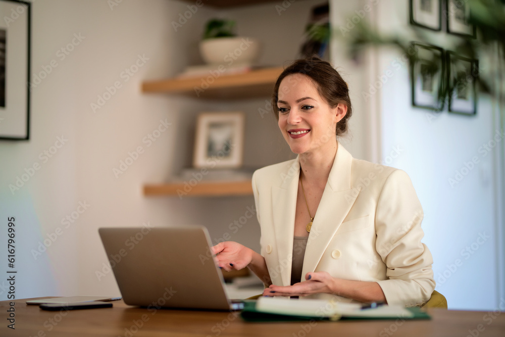 Young businesswoman with laptop having video call and working from home Young businesswoman with laptop having video call and working from home