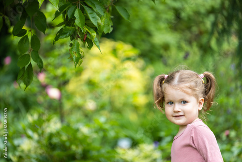 toddler girl with a bully face is outdoors among nature