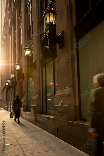 People walking on sidewalk in the financial district 