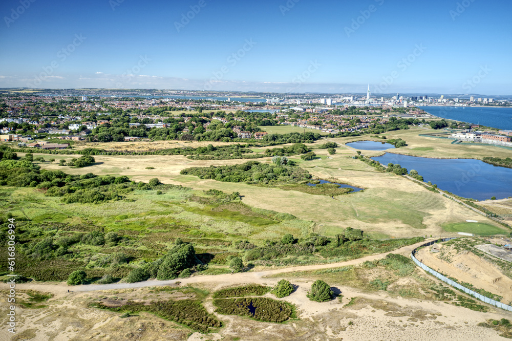 Aerial view over Gilkicker Lagoon and Gosport and Stokes Bay 9 hole Golf Course towards the naval town of Portsmouth.