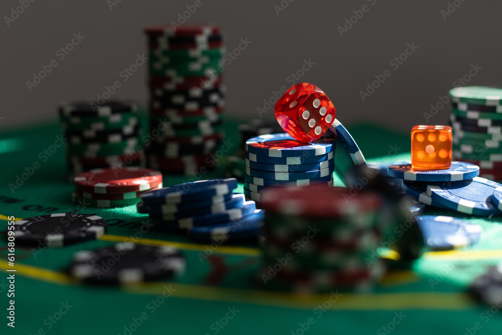 Poker Chips on a gaming table with dramatic lighting