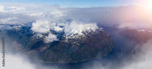 Canadian Coastal Mountain Landscape covered in Clouds. Aerial Panorama