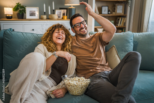 Couple caucasian man and woman sit at home on sofa bed watch tv movie