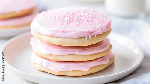 Stack of pink frosted sugar cookies on white plate with neutral colors, --aspect 16:9 