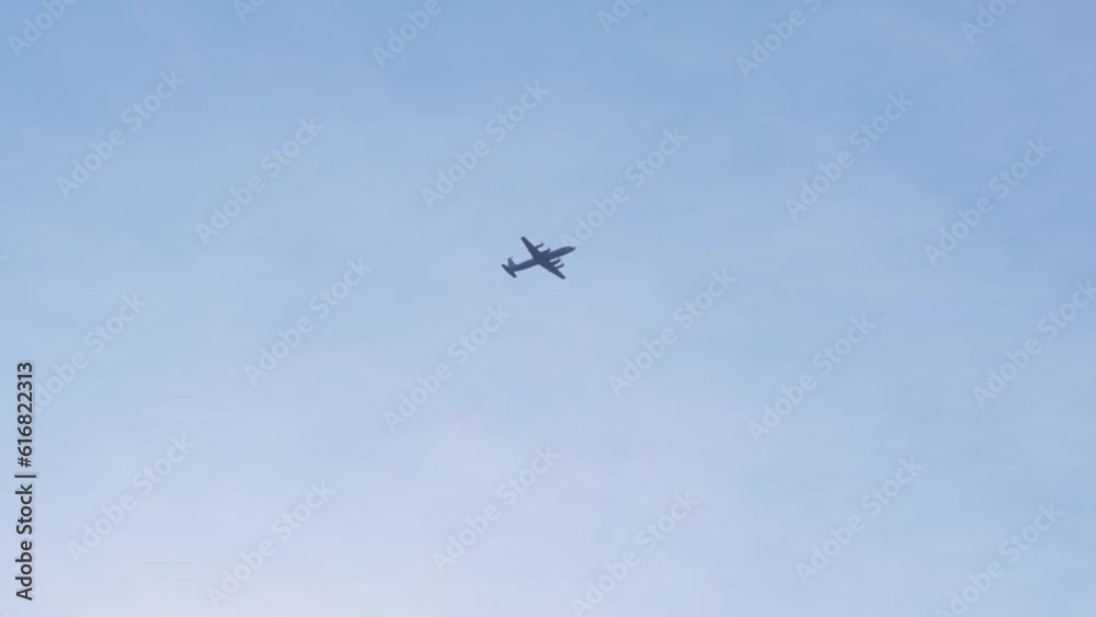 A military aircraft high in the sky. A military aircraft high in the sky.