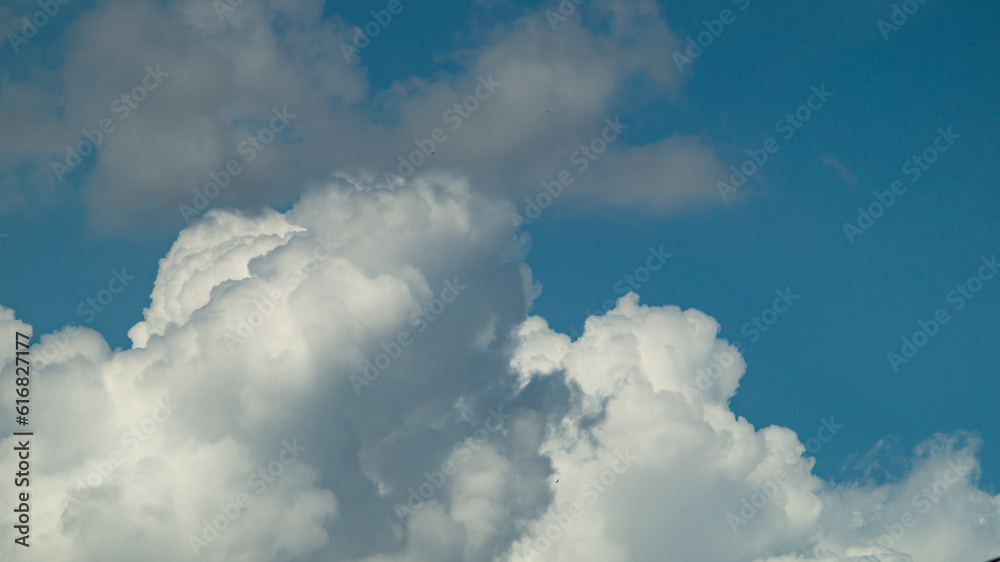 White fluffy cloud. Fluffy clouds at the blue sky. White cloud closeup White fluffy cloud. Fluffy clouds at the blue sky. White cloud closeup