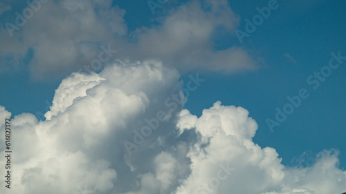 White fluffy cloud. Fluffy clouds at the blue sky. White cloud closeup