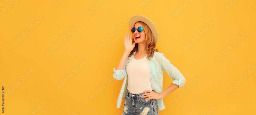 Portrait of happy excited surprised young woman wearing summer straw hat and sunglasses on yellow background Portrait of happy excited surprised young woman wearing summer straw hat and sunglasses on yellow background