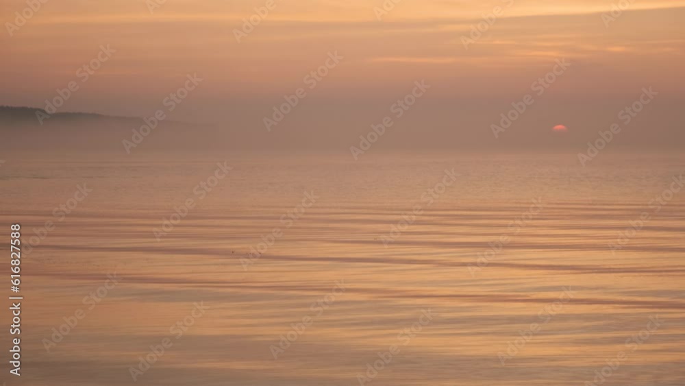 Smooth surface of water in mist against background of sunrise. Smooth surface of water in mist against background of sunrise.