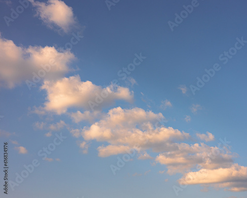 Puffy white clouds on blue sky