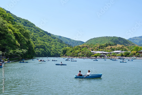 Landscape of people in rowing boats on Katsura River in Arashiyama, Kyoto, Japan. © Ladanifer