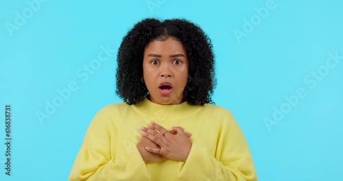 Shock, fear and face of a woman with relief on a green screen isolated on a blue background in a studio. Portrait, anxiety and a young girl with a panic attack, trauma or scared reaction with a sigh