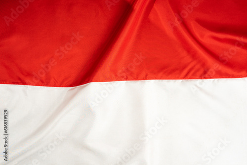 Indonesian national flag. Wavy red and white fabric texture