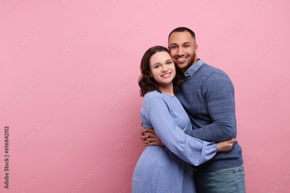 Lovely couple hugging on pink background, space for text. Valentine's day celebration Lovely couple hugging on pink background, space for text. Valentine's day celebration