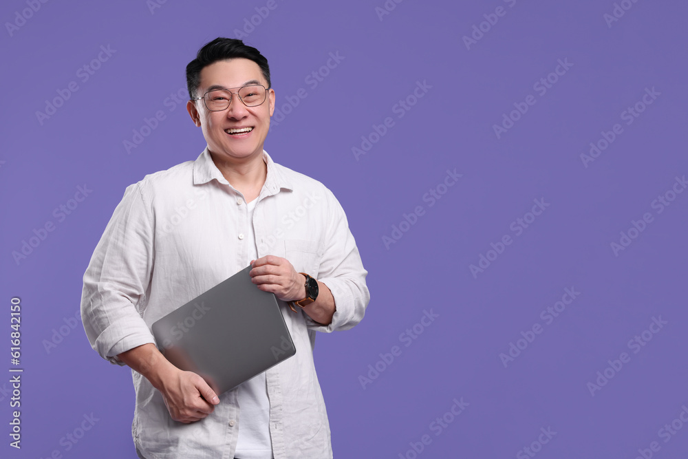 Happy man with laptop on lilac background, space for text Happy man with laptop on lilac background, space for text