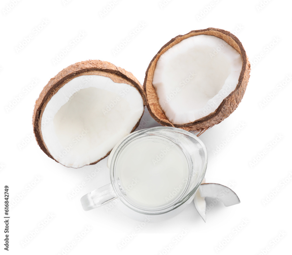 Glass jug of delicious vegan milk and coconuts on white background, top view Glass jug of delicious vegan milk and coconuts on white background, top view