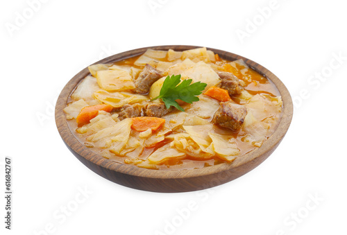 Tasty cabbage soup with meat, carrot and parsley on white background