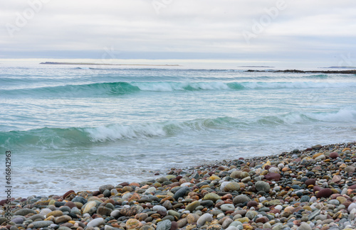 pebbled beach and Atlantic sea with waves photo