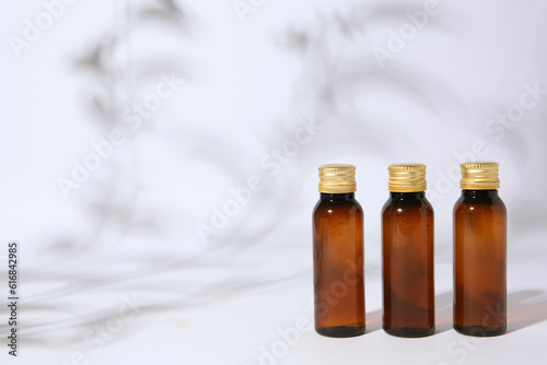 Bottles of cosmetic products on white background. Space for text